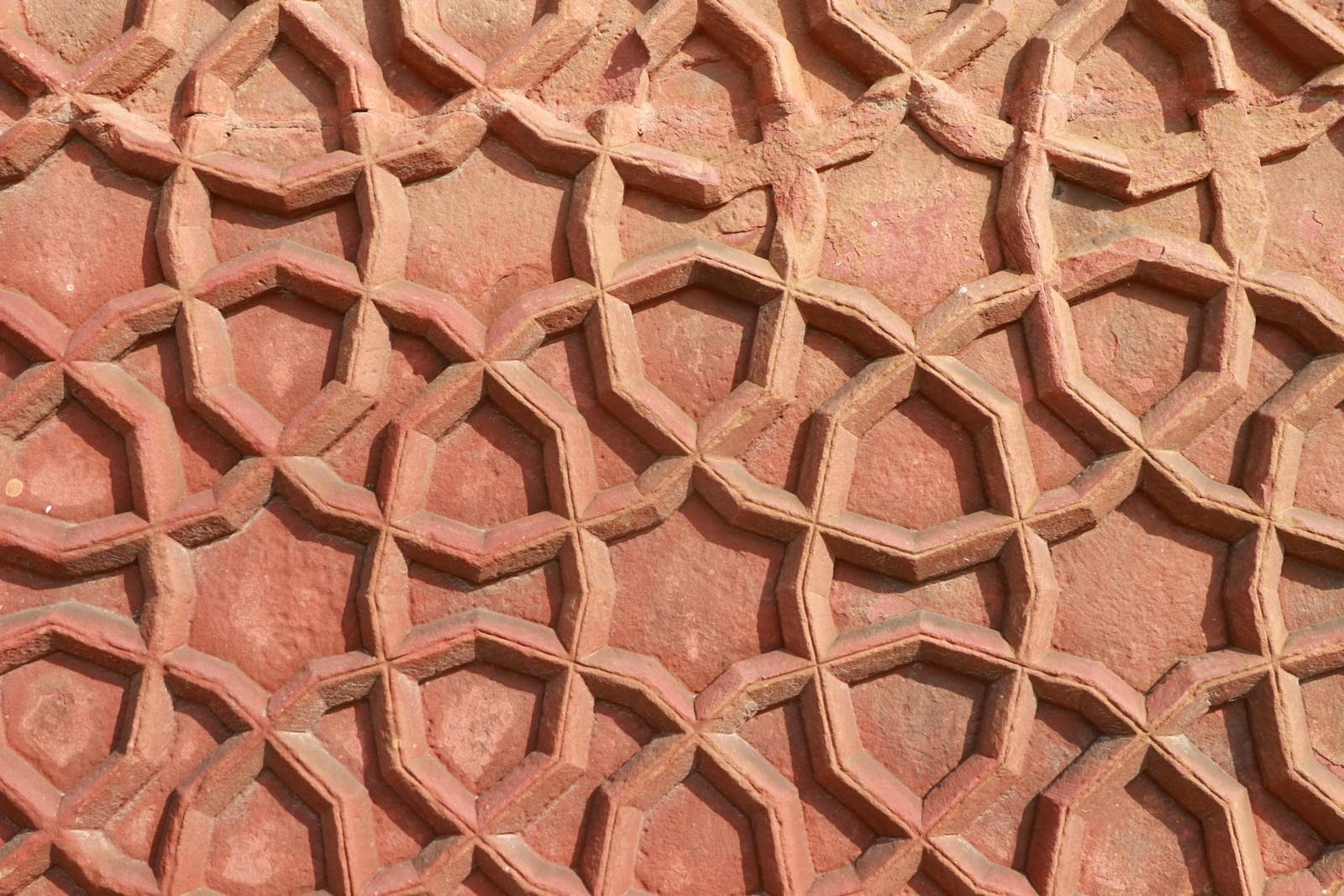 A close up of a brick wall with a pattern on it
